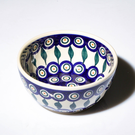 Blue and white ceramic bowl with hand-painted circular motifs, viewed from above showing interior pattern detail