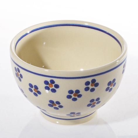 Cream ceramic bowl with blue floral pattern, front view showing rounded shape and decorative rim