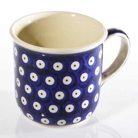 Navy blue ceramic mug with white circular pattern and cream interior, front view
