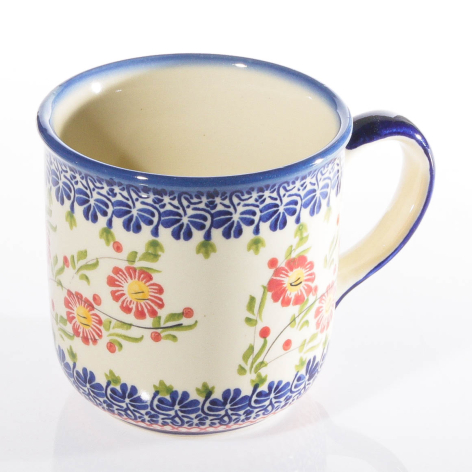 Cream ceramic mug with blue rim and handle, decorated with colorful wildflower pattern and blue ornamental border