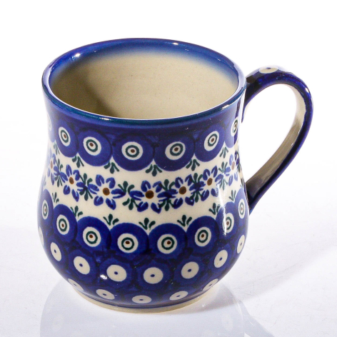 Navy blue ceramic mug with white geometric and floral pattern, front view on white background