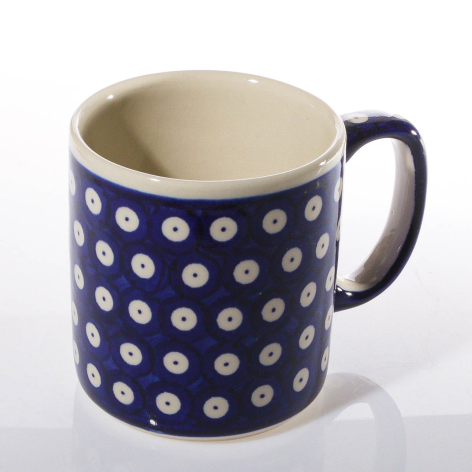 Navy ceramic mug with white circular motifs and cream interior, front view
