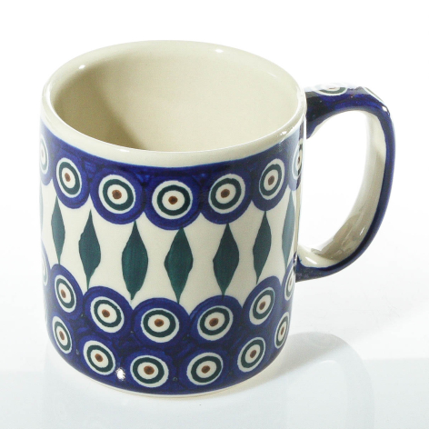Navy blue ceramic mug with cream interior, featuring geometric circles and leaf pattern design, front view