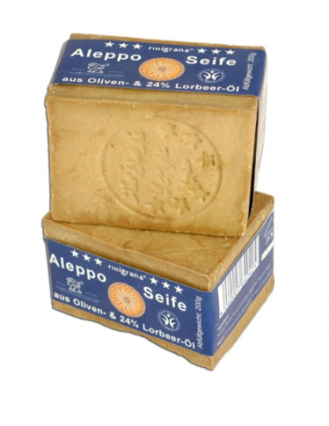 Two stacked kraft paper boxes with blue labels containing golden-hued handcrafted textile or fabric product, front view