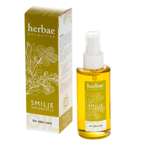 Golden yellow oil spray bottle with white label next to olive-green box packaging with botanical leaf illustration