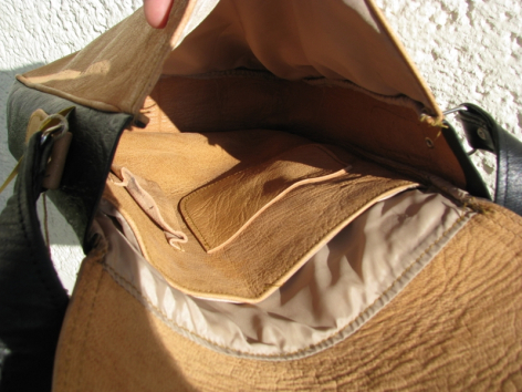 Hellbraune Ledertasche, offen von oben, zeigt geräumiges Innenfutter und strukturierte Seitenwände