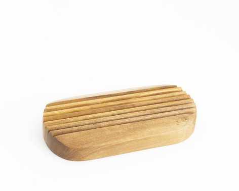 Wooden serving board with natural light grain finish and rounded edges, angled view