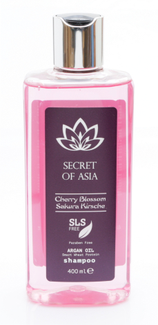 Purple room spray bottle with silver pump top and white lotus logo on label, front view