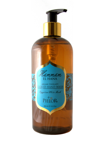 Amber glass bottle with gold pump dispenser and blue label on front, product packaging shot against white background