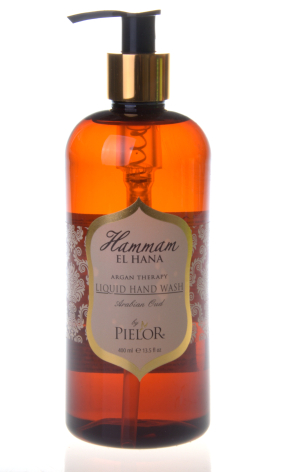 Amber glass bottle with black pump dispenser and beige label, front view