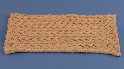 Woven tan textile with textured surface pattern, rectangular shape, flat lay view