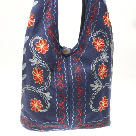 Navy blue embroidered shoulder bag with orange floral motifs and red geometric patterns, front view