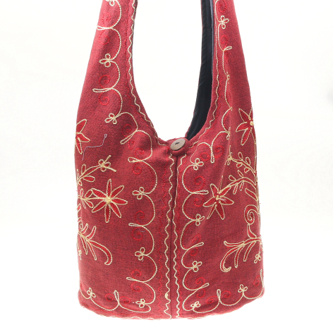 Red velvet hobo bag with gold embroidered floral pattern and central zip closure, front view