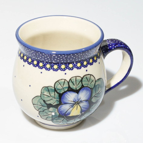 Hand-painted ceramic mug in cream with blue floral design and dotted blue band detail, front view