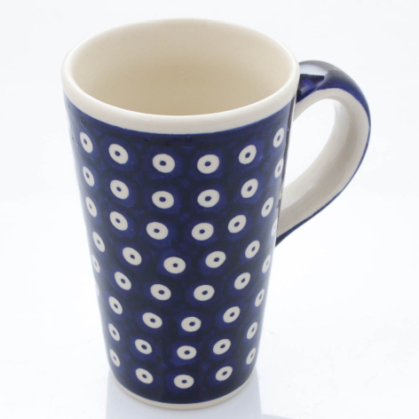 Navy blue ceramic mug with white floral dot pattern and cream interior, cylindrical shape with handle