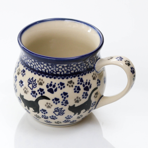 Navy blue and cream ceramic mug with floral pattern and curved handle, front view