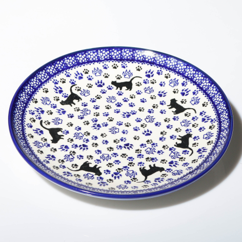 Blue and white ceramic bowl with hand-painted floral motifs and decorative border, viewed from above