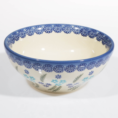 Blue and cream ceramic bowl with decorative border and hand-painted floral details on lower body, shown from front angle