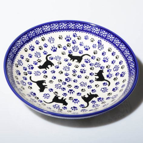 Blue and white ceramic bowl with hand-painted floral pattern and decorative rim, overhead view