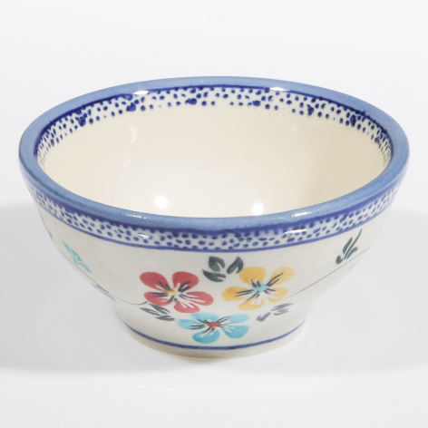 Ceramic bowl with blue rim and floral motifs, cream interior, handcrafted design shown from front angle