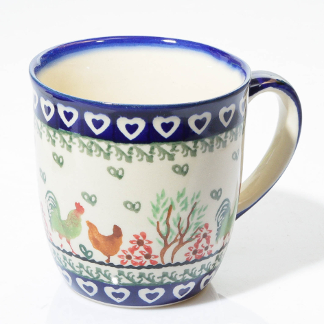Blue and white ceramic mug with hand-painted heart and floral motifs, front view