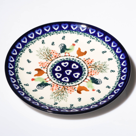 Handcrafted ceramic bowl with deep blue rim, cream center, and floral motifs in traditional Central Asian design