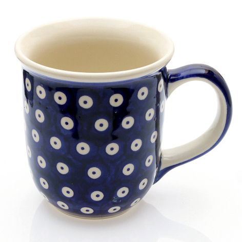 Navy blue ceramic mug with white dotted pattern and cream interior, front view