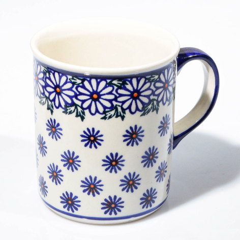 Cream ceramic mug with blue floral pattern and matching blue handle, front view