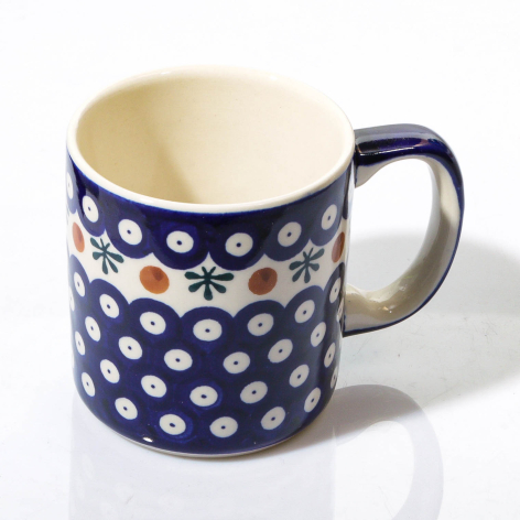 Navy ceramic mug with white geometric pattern, cream interior, cylindrical shape shown from front angle
