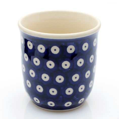 Navy ceramic cup with white geometric circle pattern, cylindrical shape with cream interior