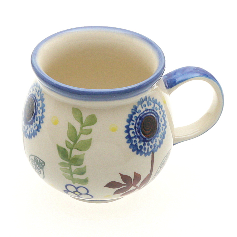 Cream ceramic mug with blue floral medallion pattern and blue rim, front view