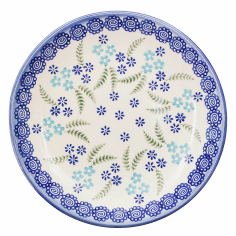 Blue and white ceramic plate with scattered floral motifs and decorative border, top-down view