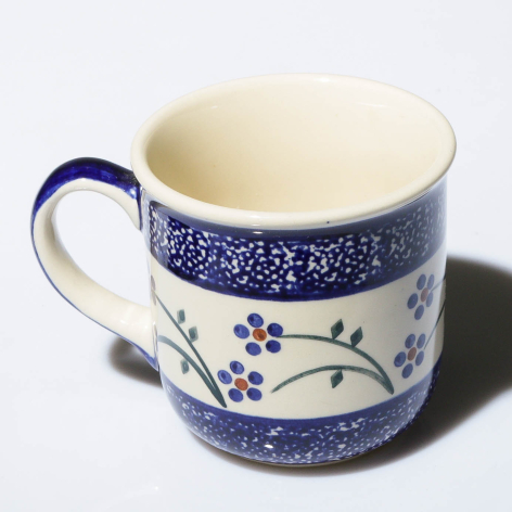 Blue and cream ceramic mug with hand-painted floral pattern and textured speckled bands, front view
