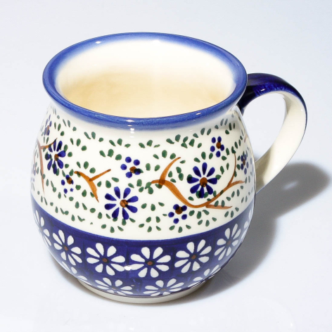 Blue and cream ceramic pitcher with hand-painted floral pattern, front view showing decorative bands and curved handle