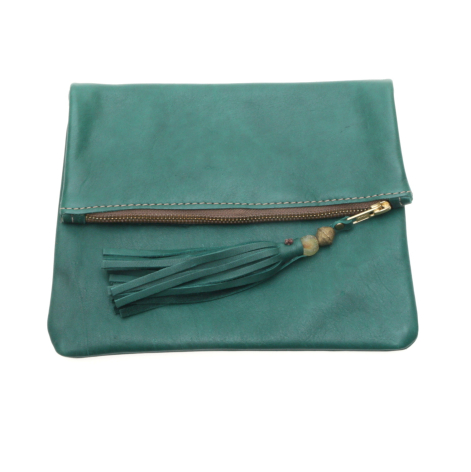 Teal suede fold-over clutch with magnetic closure and decorative leather tassel, front view