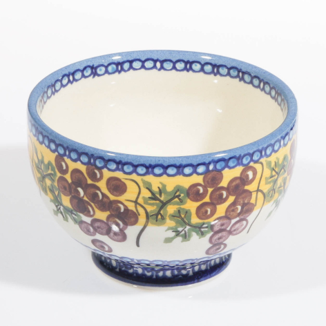 Blue ceramic bowl with hand-painted floral motif in red and yellow, front view showing decorative rim and cream interior