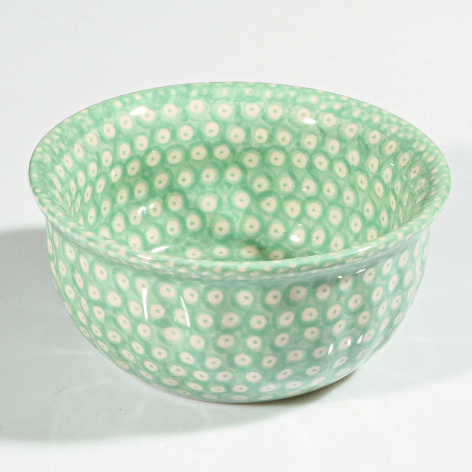 Mint green woven bowl with white polka dot pattern, shown from front angle with visible interior depth