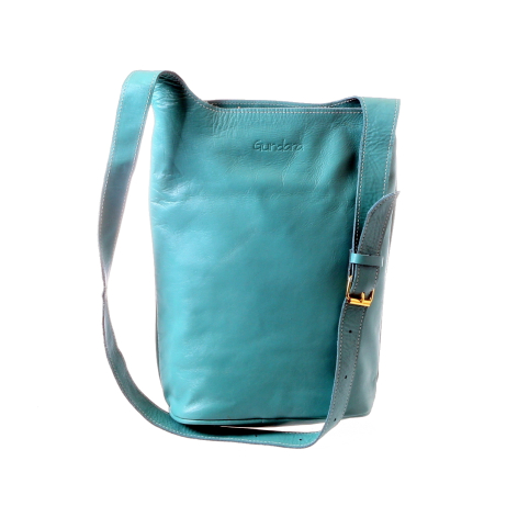Turquoise leather bucket bag with adjustable shoulder strap and brass hardware, front view