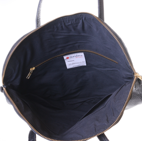 Navy leather tote bag, open view showing dark blue interior with zipper pocket and brand label