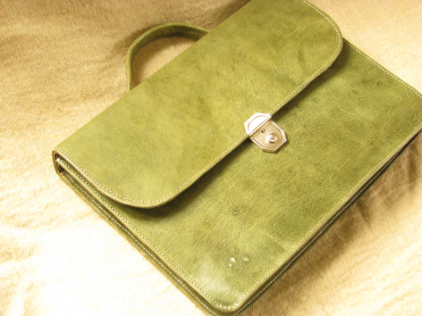 Lime green leather shoulder bag with flap closure and circular mother-of-pearl button, front view