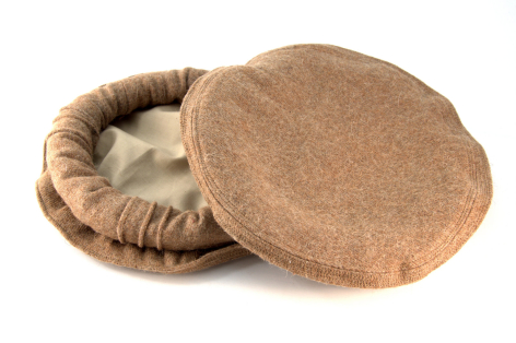 Tan round storage basket with lid, woven natural fiber construction shown open to reveal cream-colored interior lining