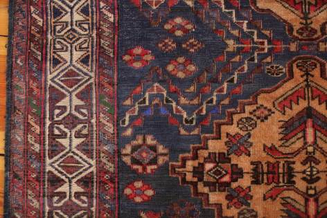 Woven textile with geometric diamond and tribal patterns in navy blue and rust orange