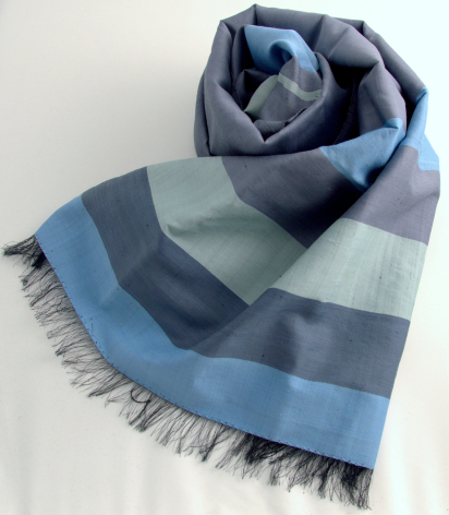 Blue and grey striped cotton scarf with fringed edges, folded to show color blocking pattern