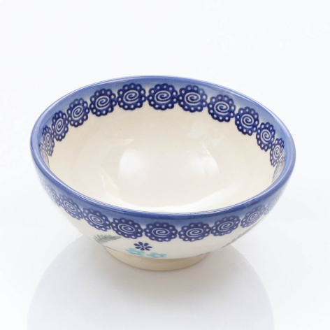 Blue and cream ceramic bowl with hand-painted decorative pattern around the rim, front view