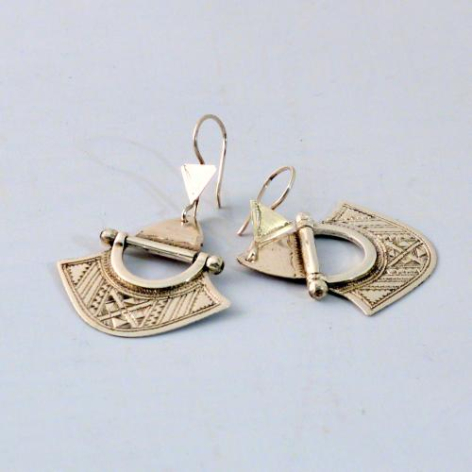 Brass fan-shaped earrings with textured surface and silver hooks, displayed against neutral background