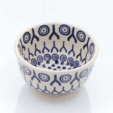 White ceramic bowl with blue geometric and circular patterns in repeating rows, front view