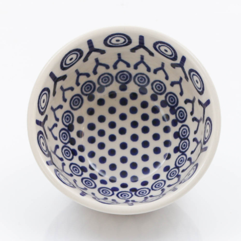 White ceramic bowl with blue floral and dot pattern, overhead view showing interior design