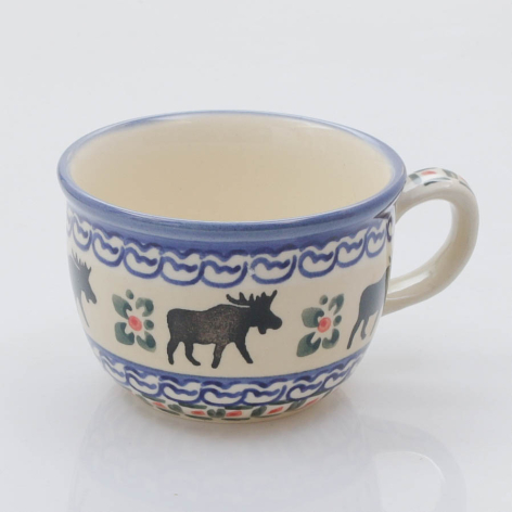 Cream ceramic cup with blue decorative border and silhouettes of animals, front view