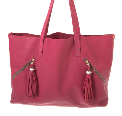 Hot pink leather tote bag with dual handles and decorative tassel zipper pulls, front view