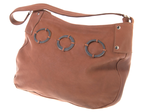 Terracotta leather shoulder bag with circular embossed details and adjustable strap, front view
